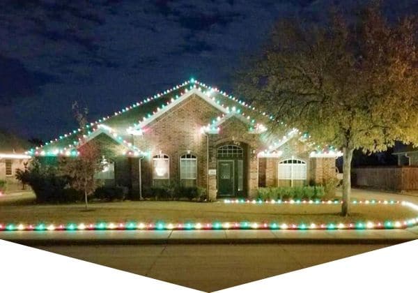 Home in Burleson, Texas that has lovely Christmas light display installed by Worsham's Lawn Service.