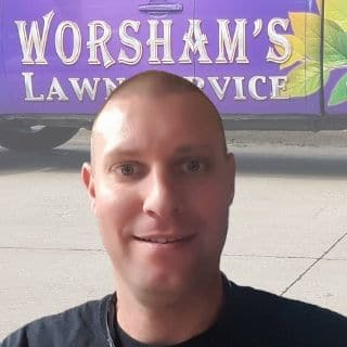 Josh Worsham headshot with work truck in background.