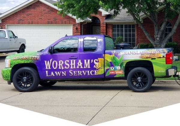 Pick up truck with Worsham's Lawn Mowing logo.
